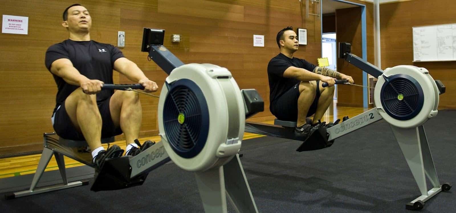 men working out using a rowing machines