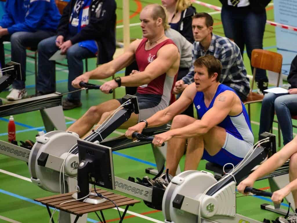 men using rowing machines